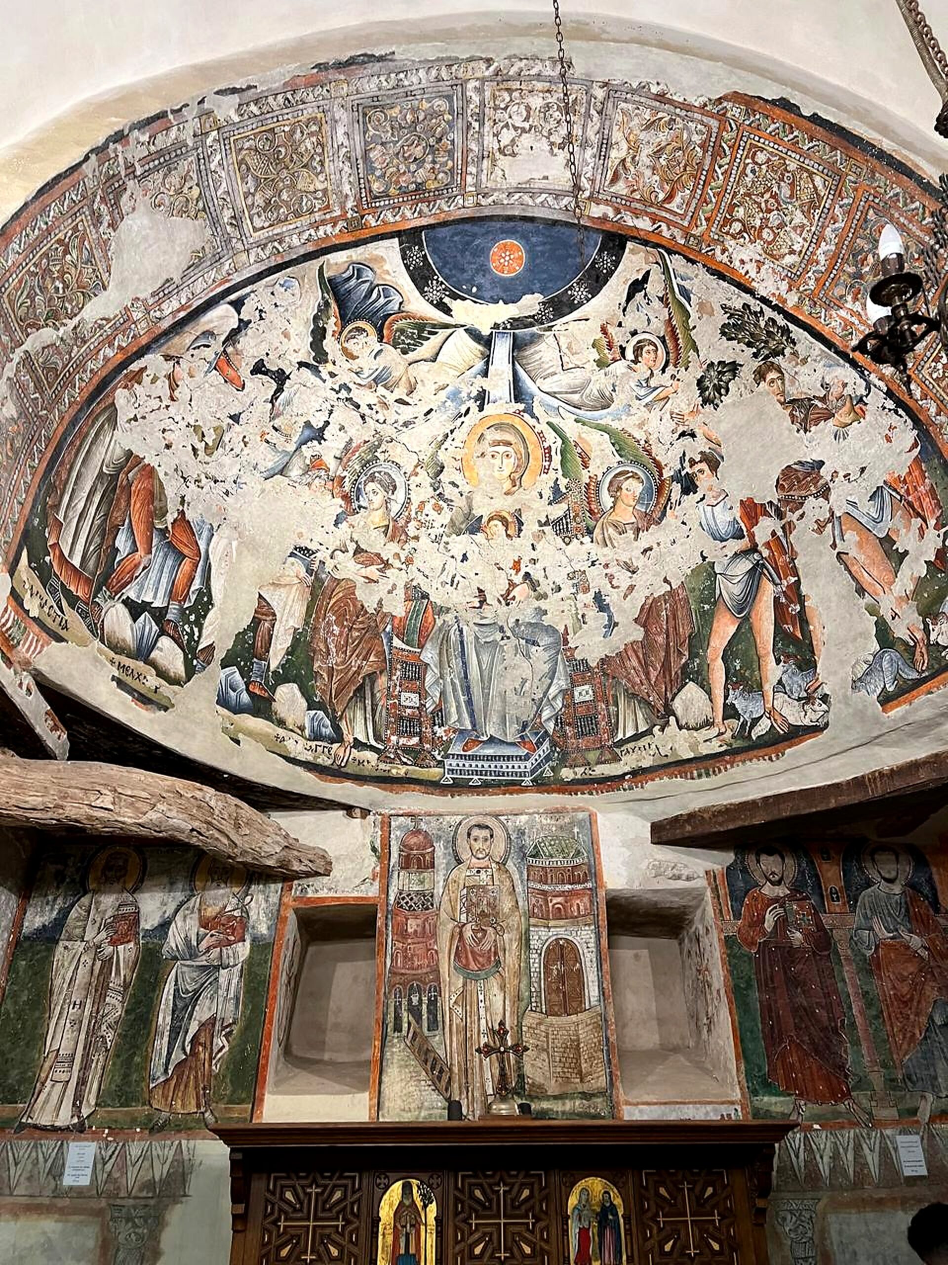Historic Coptic church fresco showing sacred figures and painted arch