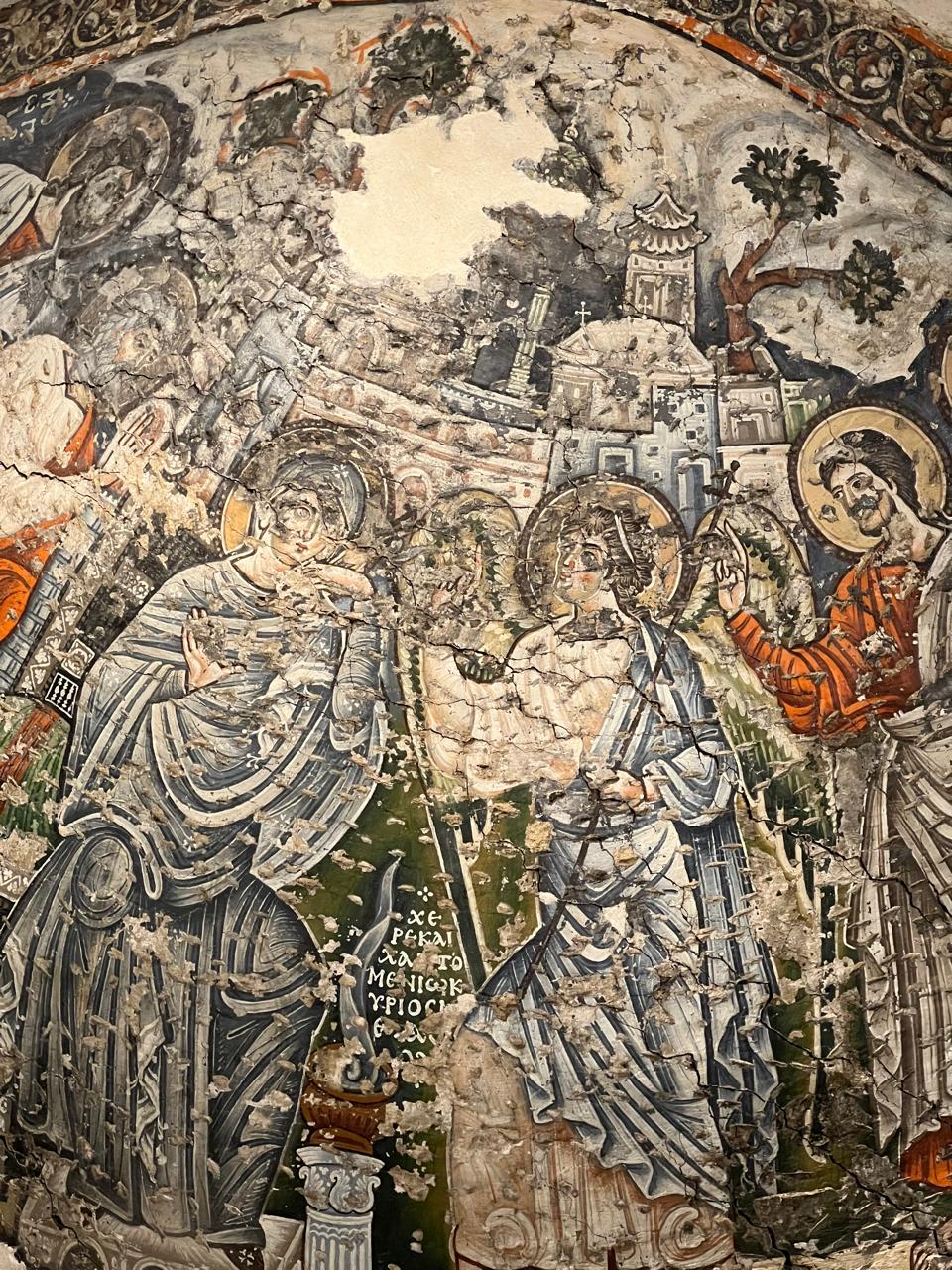 Weathered historic Coptic Christian wall painting depicting religious figures