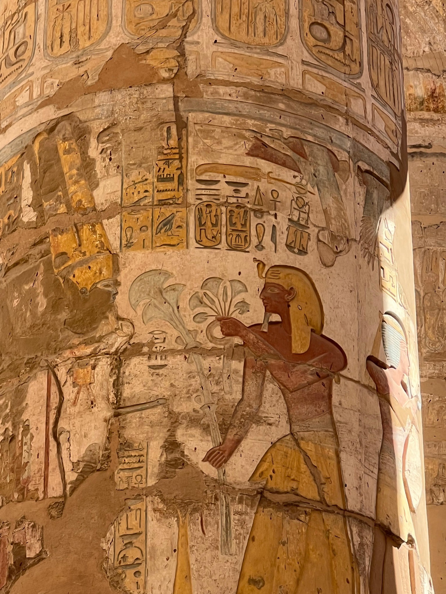 Colorful ancient Egyptian painted relief and hieroglyphs on a Karnak temple column