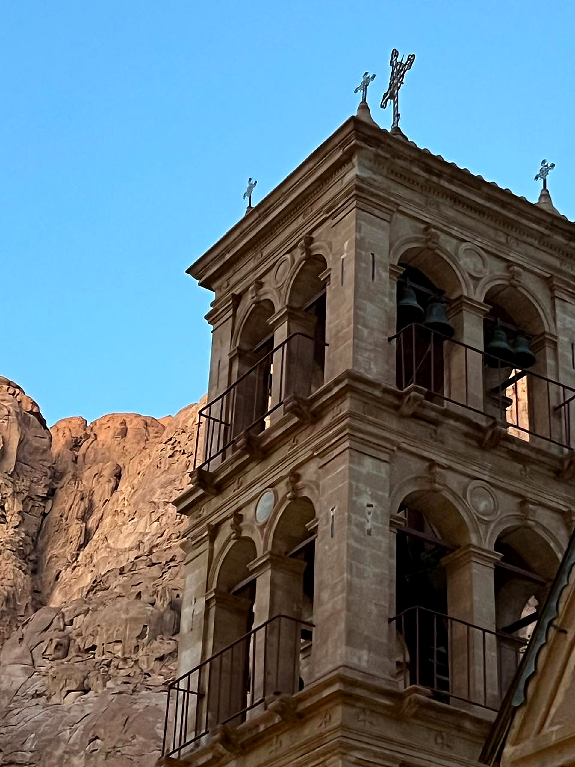 Historic bell tower of Saint Catherine's Monastery against Sinai mountains and blue sky